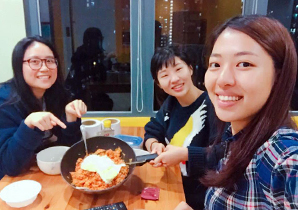 Jieun making Korean food with her friends at the hostel